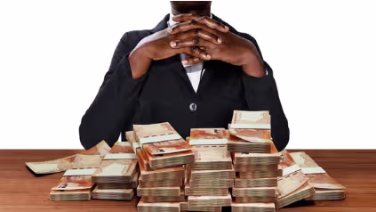 Hands holding stack of dollar bills